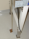 Biological safety cabinet bolted to the floor with a metal brace
