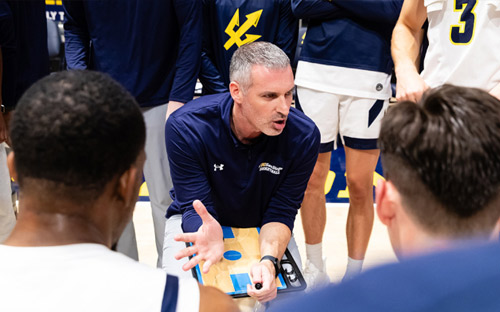 Now in his 12th season as head coach, Eric Olen has transformed men's basketball at UC San Diego, guiding the program through the Division I transition and leading the 2024-25 team to the Big West Men's Basketball Championship in the first year of the program's full Division I eligibility. Photo credit Derrick Tuskan/UC San Diego.