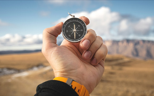 hand holding a compass