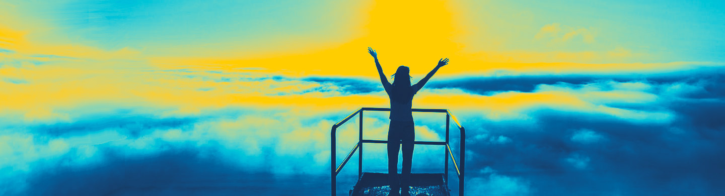 Woman silhouette with arms raised in joy