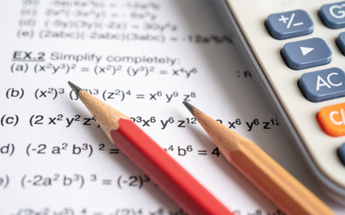 Pencil, calculator, and paper with equations