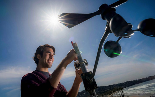 A graduate student checks a weather monitoring station at the Scripps Institution of Oceanography used for UC San Diego’s Decision Making Using Real-Time Observations for Environmental Sustainability program that provides data for a number of university research projects.