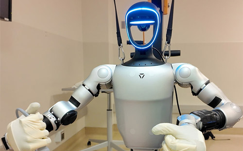 White humanoid robot holding surgical instrument