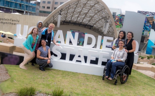 Staff Association around a giant 3-D STAFF sign.