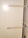 Freezer tethered to wall-anchoring system.