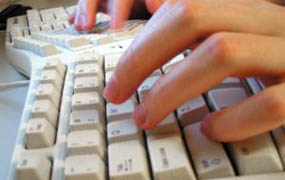 hand typing on a keyboard