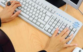 person typing on a keyboard