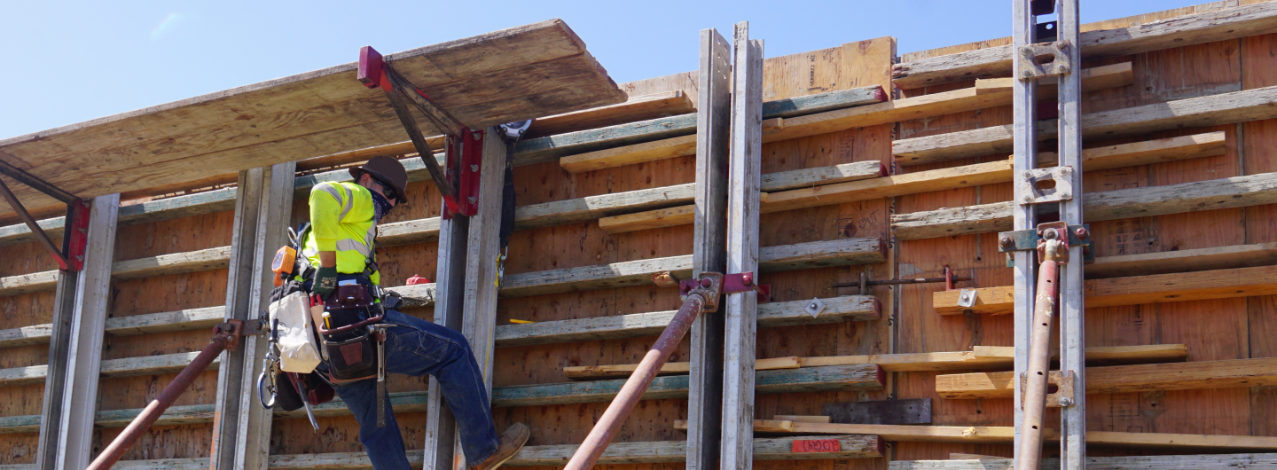 Construction retaining wall and worker